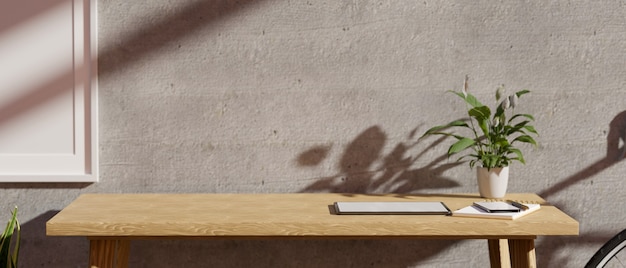 Photo closeup modern minimalist workplace with copy space on a wooden table against grey cement wall 3d