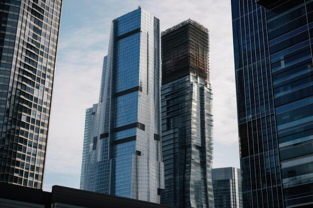 Closeup of modern skyscraper with city skyline visible in the background