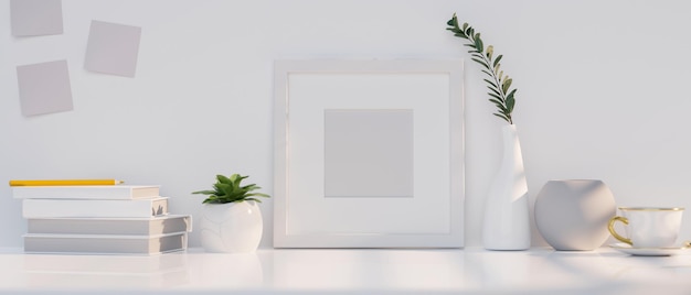 Closeup Modern white table with white empty picture frame mockup and white accessories