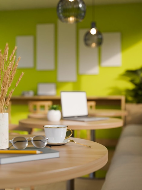 Closeup Modern wood table with accessories in modern trendy green coffee shop seating area