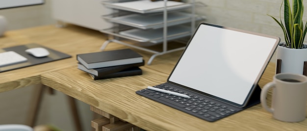 Closeup of a modern work station interior with tablet screen mockup on a wooden table 3d rendering