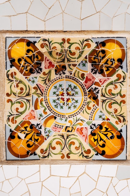 Closeup mosaic antonio gaudi in the park guell barcelona