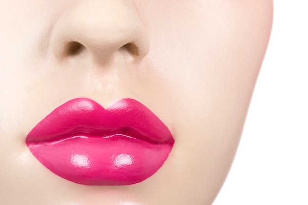 Photo closeup of the mouth of a female mannequin with pink lips