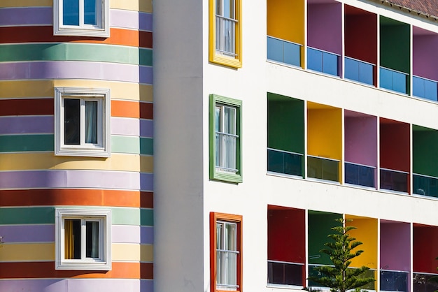 Closeup of a multicolored apartment building with glass balconies