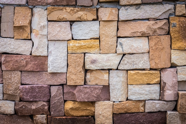 Closeup of multicolored old brick wall background.