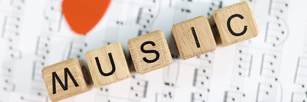 Closeup of music word collected from wooden cubes and musical notes music art and musical