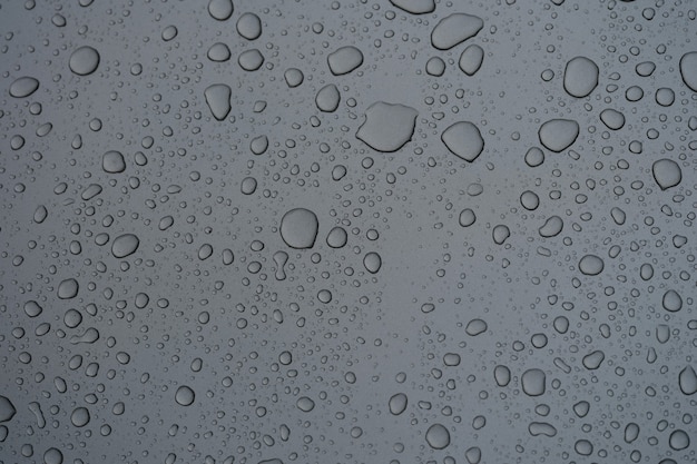 Closeup of natural pattern of water drops on glass