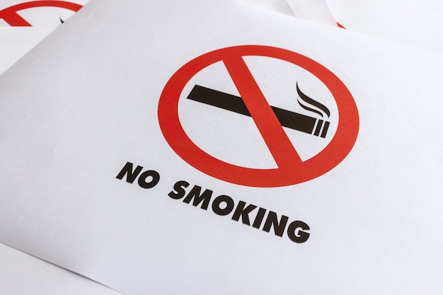 Closeup no smoking sign on white paper 