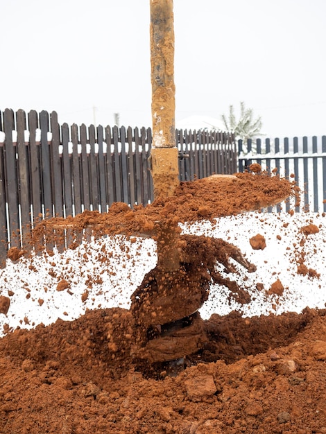 Closeup of a nozzle on a hydraulic drill for digging wells of\
wells mud earth sand drilling operations in winter