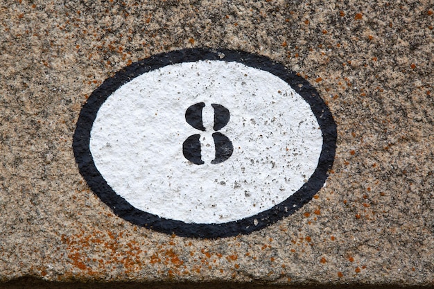 Closeup of Number Eight on Stone Wall