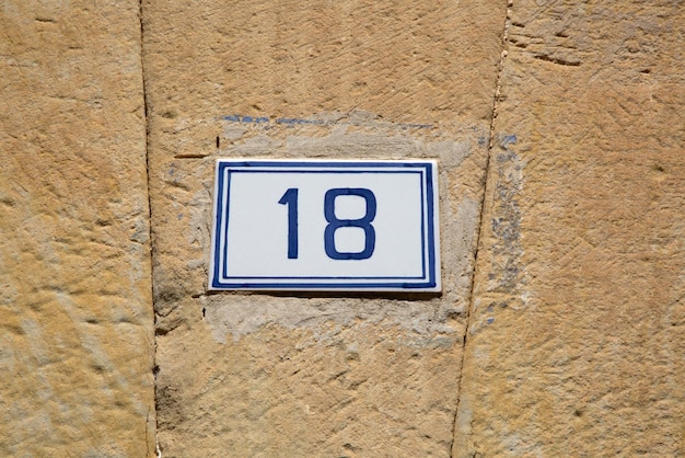 Closeup of Number Eighteen on Stone Wall