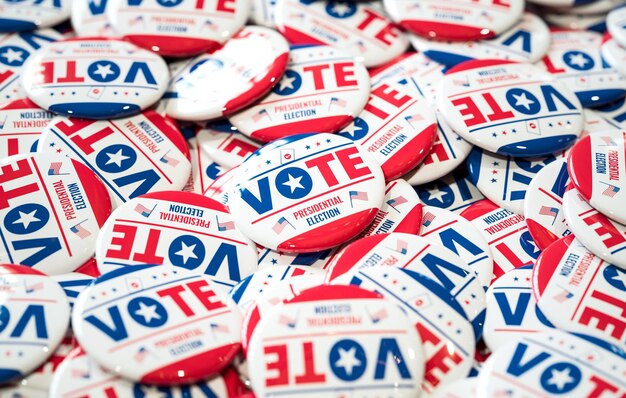 A closeup of numerous Vote buttons promoting the United States of America presidential election