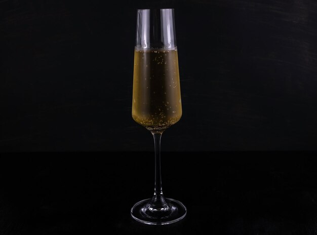 Фото Крупный план бокала шампанского на темном деревянном фоне