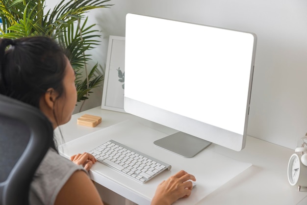 Closeup office worker Asian woman typing on keyboard computer white screen at home office Concept of technology connection communication Clipping path on white screen isolated