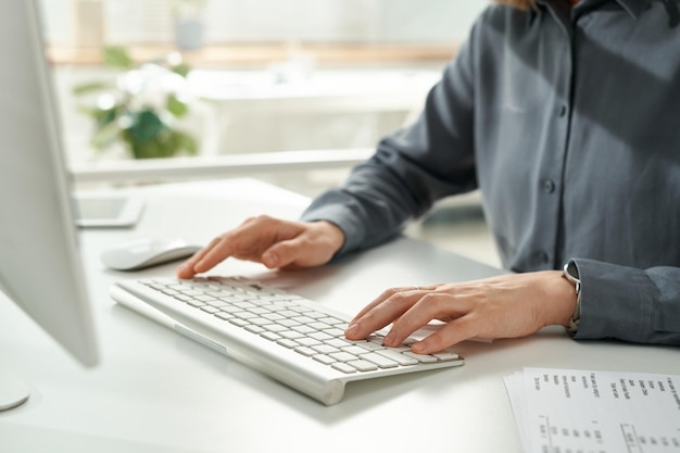 Closeup of office worker working on computer at office she sitting at table and typing on keyboard