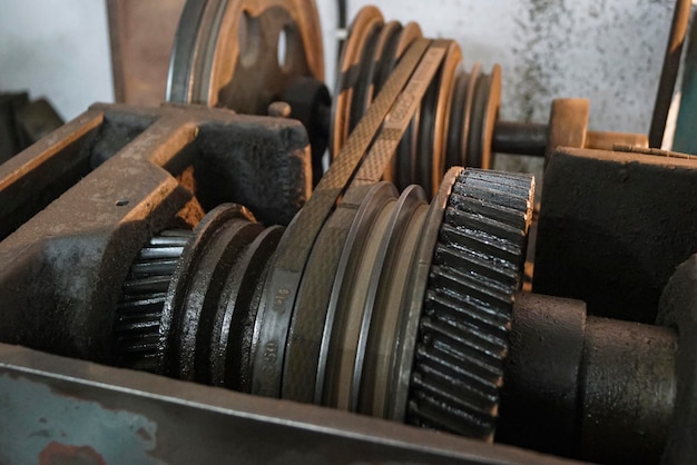 Closeup of oily metal gears and belt of old Lathe Machinery