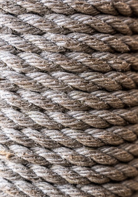 Closeup of an old frayed boat rope as a nautical\
background