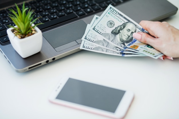 Closeup of One Female Caucasian Hand Holding Many Dollars