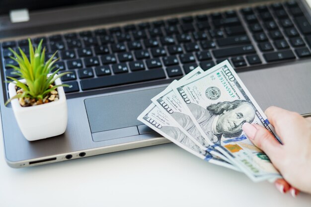 Closeup of One Female Caucasian Hand Holding Many Dollars