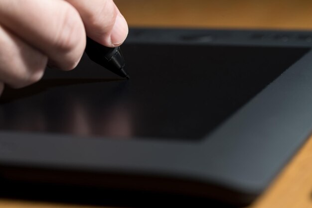 Closeup Of One Hand Drawing On A Computer Graphics Tablet