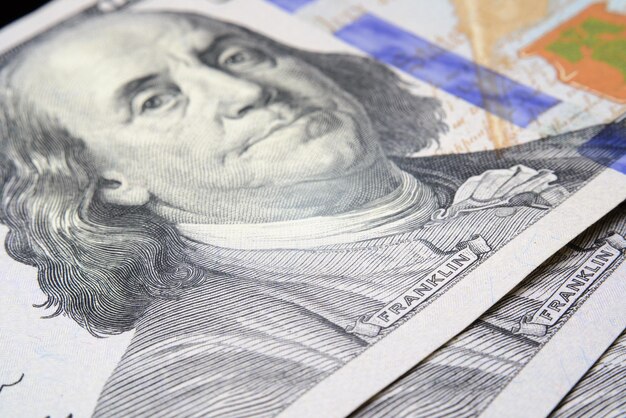 Closeup of one hundred dollars on wooden table