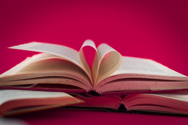 Closeup of open books on colored background