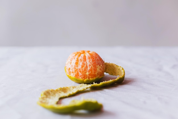 Closeup The oranges on the table on white backdrop The oranges have green peel peeling orange