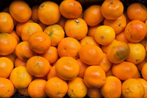 Closeup of organic oranges piled up at a roadside stand