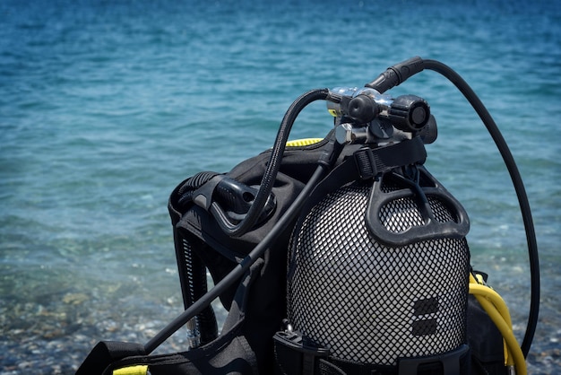 Closeup of an oxygen cylinder for diving on a clean beach