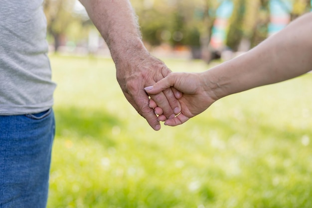 closeup of the palms of people holding hands hand in hand