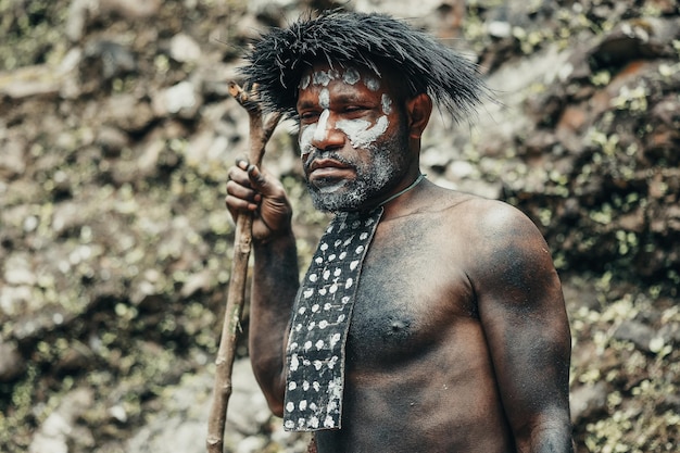 Closeup Papua man of Dani tribe against nature background