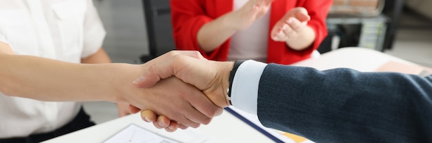 Closeup of partners handshaking at business meeting successful negotiations concept