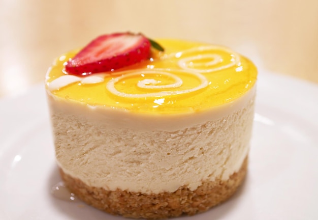 Closeup of Passion Fruit Cheese Cake Topped with Fresh Strawberry