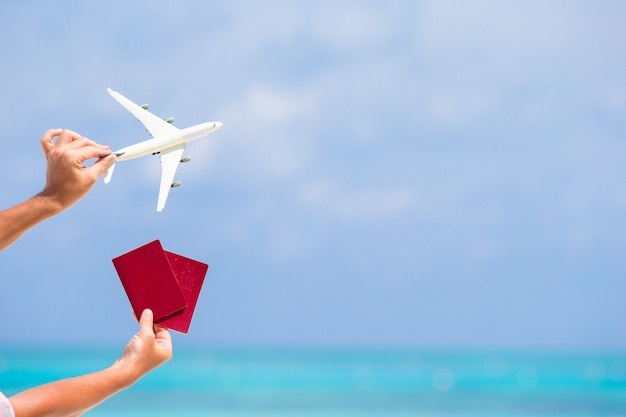 Closeup of passports and white airplane the sea