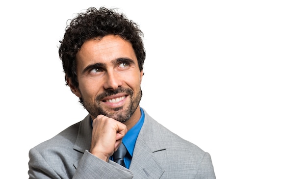 Closeup of a pensive young business man, isolated on white