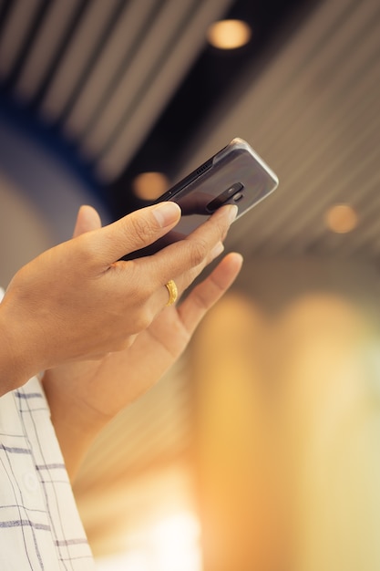 closeup of people's hands using mobile phone with fun and happy