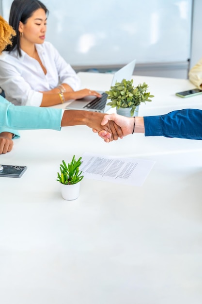 Closeup of people shaking hands in a coworking