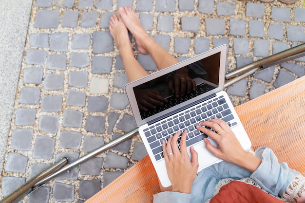 Closeup of person using laptop with relax in garden