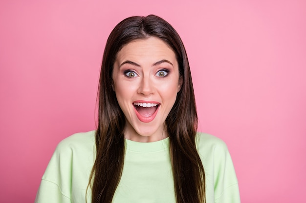 Closeup photo of attractive funny shocked lady straight long hairdo open mouth listen amazing good news wear casual green sweatshirt pullover isolated pink pastel color background