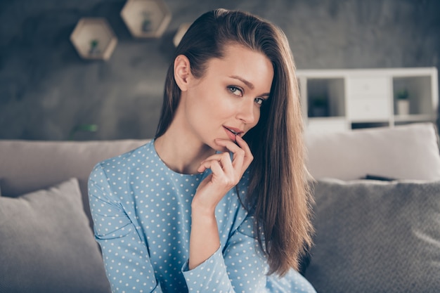 Closeup photo of attractive tender lady talk boyfriend chat client distant video call internet work teasing touch lips quarantine stay home sit couch wear blue dress living room indoors