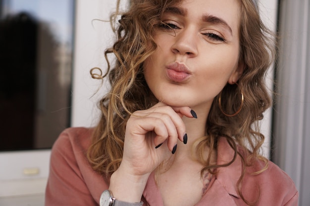 Closeup photo of beautiful funny pretty curly lady positive good mood sending air kisses