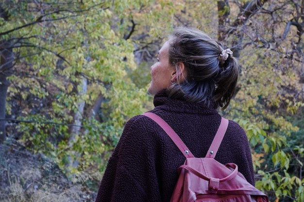 A closeup photo of a Caucasian woman from behind in nature