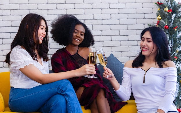 Closeup photo of cheerful girls celebrating a party at home with campaign.