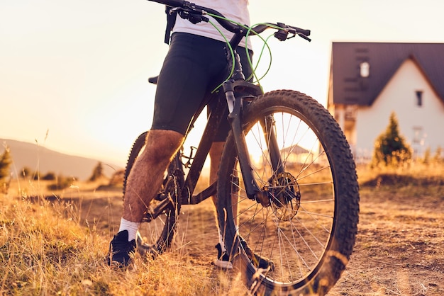 Closeup photo of a cyclist riding a bike on top of a mountain