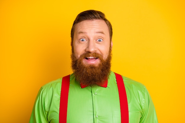 Closeup photo of excited redhair attractive guy open mouth listen good news crazy facial expression wear green shirt suspenders bow tie isolated shine color