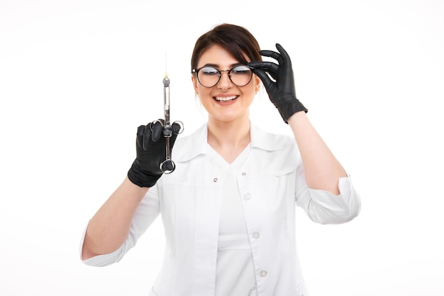 Closeup photo of female dentist in black gloves and glasses with dental stuff isolated over the withe backgrownd.