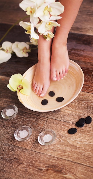 Photo closeup photo of a female feet at spa salon.