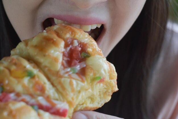 Closeup photo of food in mouth eating food