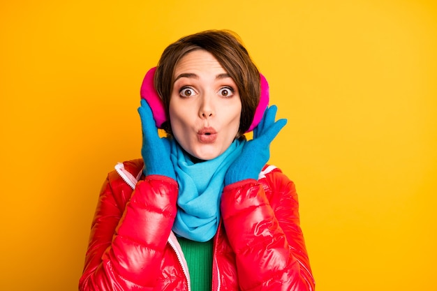 Closeup photo of funny lady nice ear warmers open mouth shocked wear stylish casual red overcoat blue scarf gloves pink earmuffs 