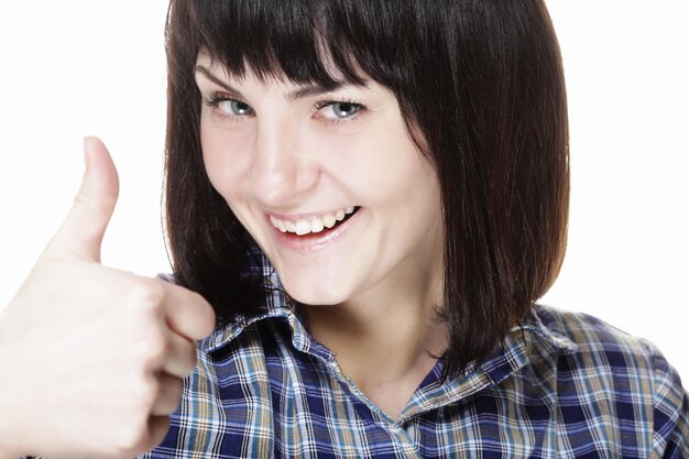 Photo closeup photo of funny young woman showing ok gesture looking at camera isolated on white background